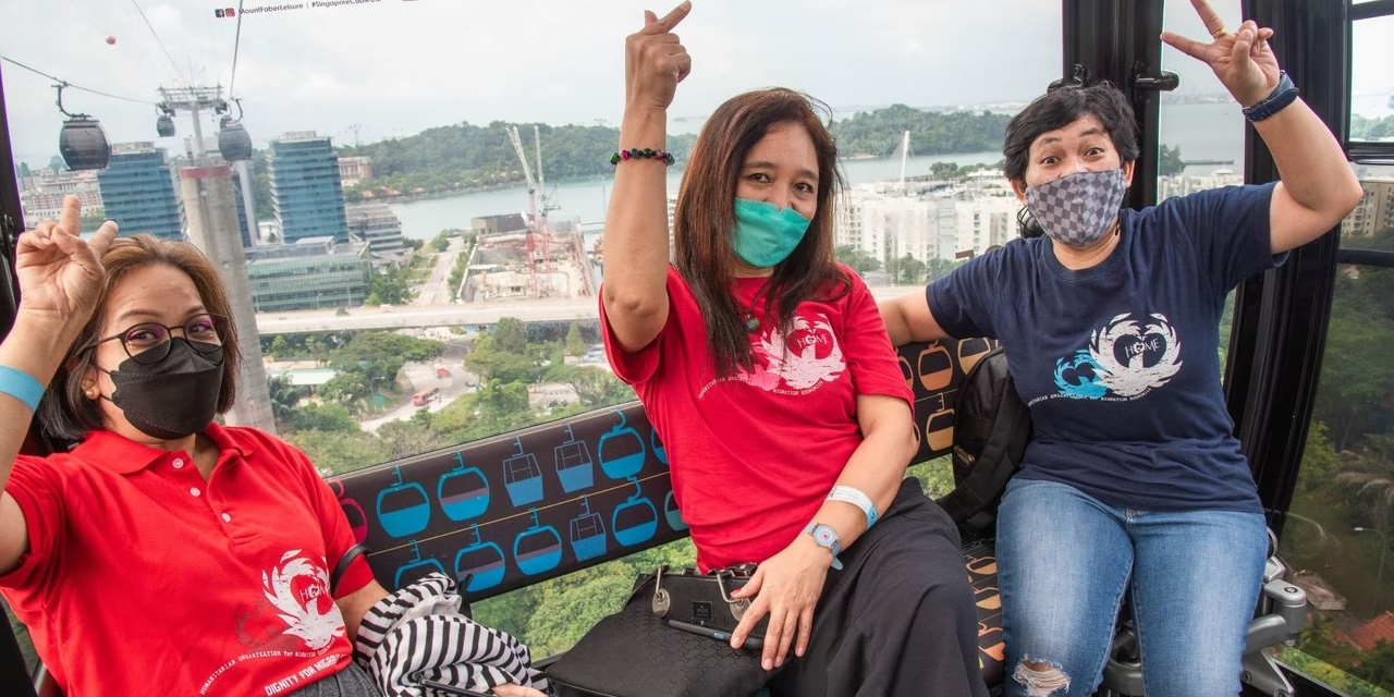Three women wearing face masks on a cable car